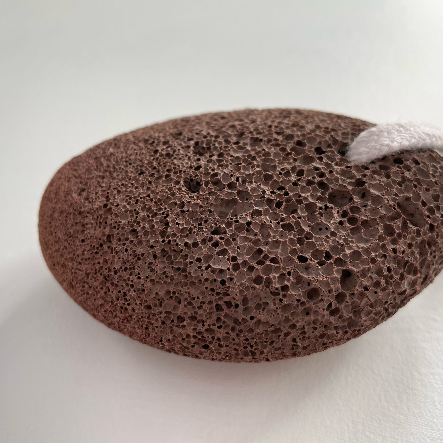 Natural exfoliating lava pumice stone on rope